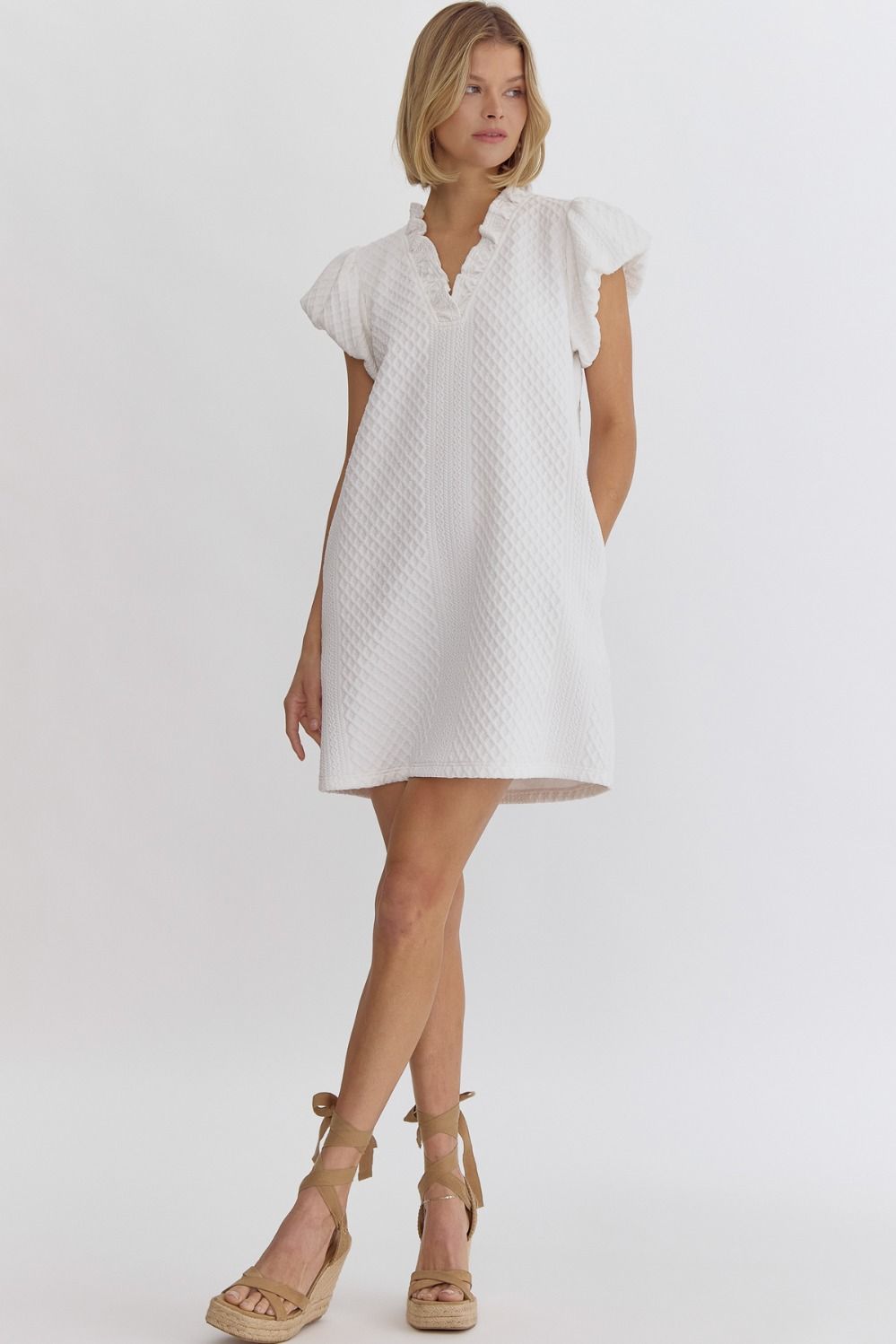 Textured short-sleeve v-neck mini dress featuring bubble sleeves.