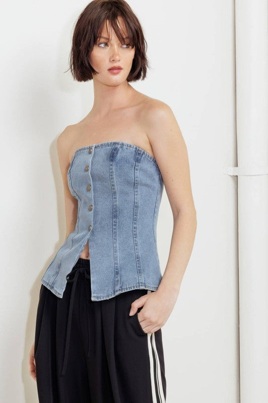 A washed denim top featuring strapless and front button down