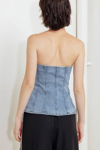 A washed denim top featuring strapless and front button down