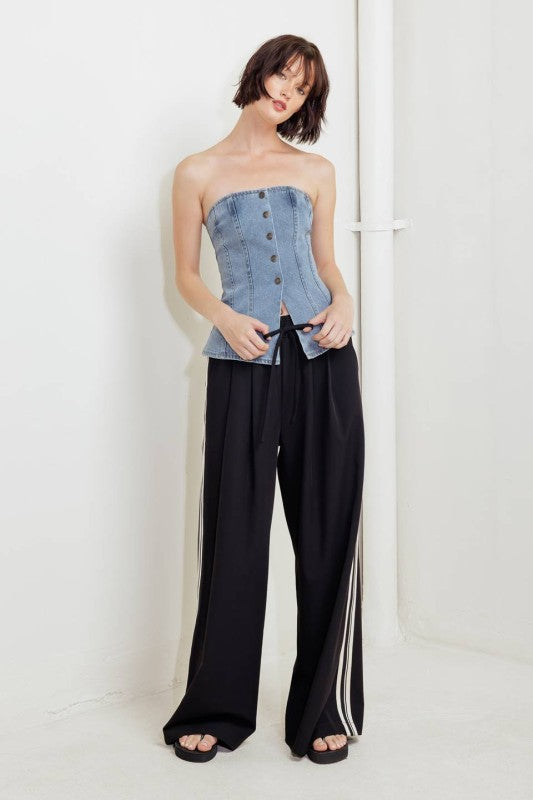 A washed denim top featuring strapless and front button down
