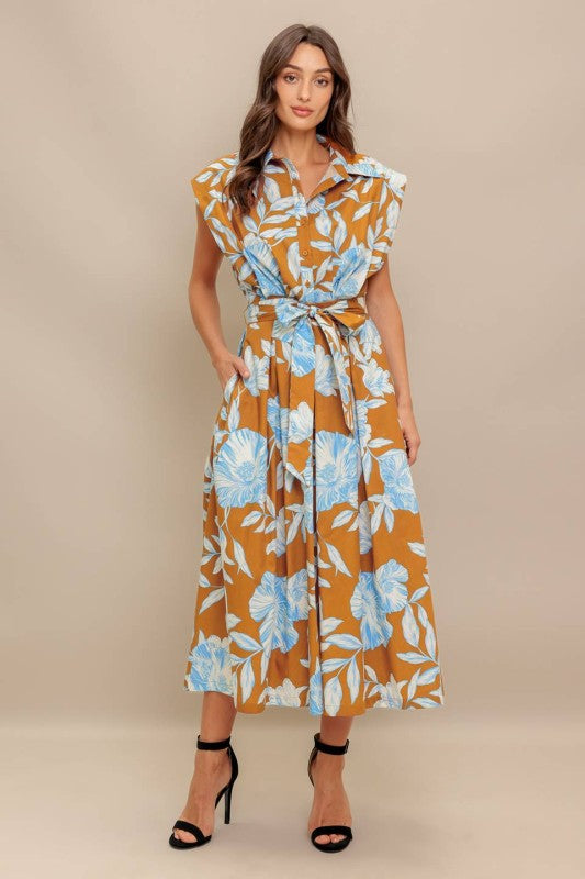A printed woven midi dress featuring collar, short sleeve, front button down, self sash tie and full skirt