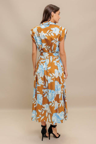 A printed woven midi dress featuring collar, short sleeve, front button down, self sash tie and full skirt