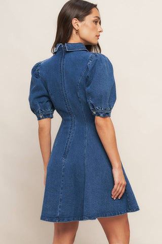 A washed denim mini dress featuring collar, front V, short puff sleeve, circle skirt and back zipper