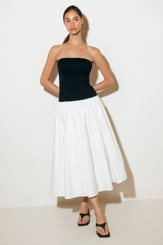 A solid midi dress featuring strapless knit bodice, full woven skirt and back zipper closure