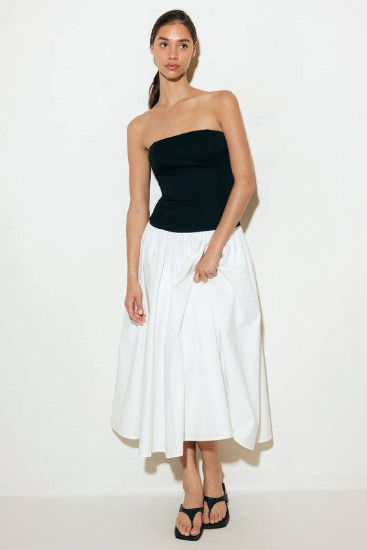 A solid midi dress featuring strapless knit bodice, full woven skirt and back zipper closure