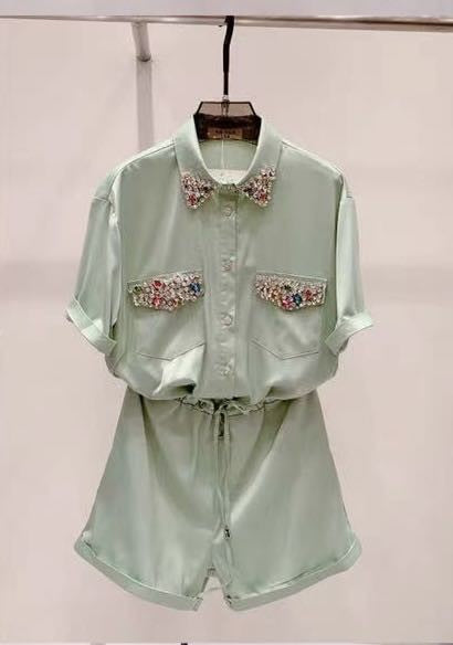 Women's silky short romper with rhinestones all around, diamonds on the collar, buttons, and pockets.