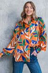 A printed woven top featuring shirt collar, button down and long sleeve