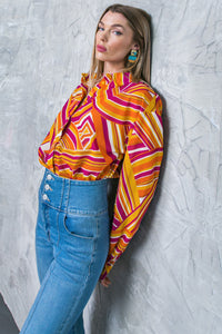 A printed woven top featuring shirt collar, button down, long sleeve and cuff