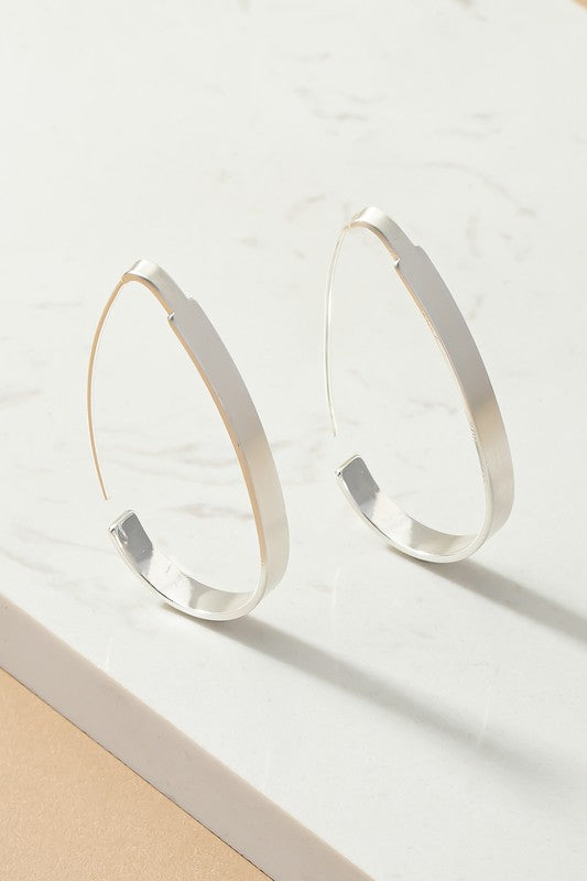 Brass flat oval hoop earrings with brushed surface