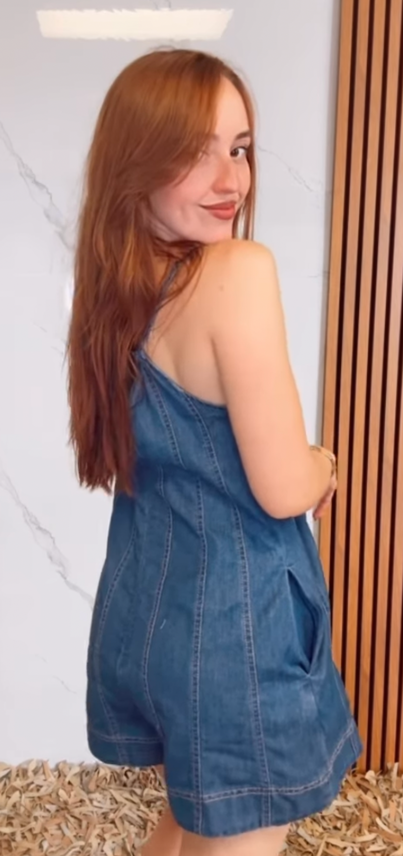A Light Denim Romper with Back Tie and Zipper Closure