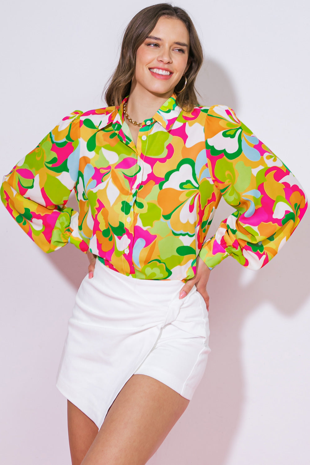 A printed woven top featuring shirt collar, button down and long sleeve with cuff