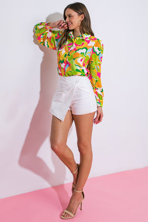 A printed woven top featuring shirt collar, button down and long sleeve with cuff