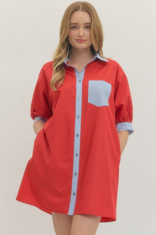 Solid collared half sleeve mini dress featuring contrast stripe placket and patch pocket at chest. Button closure at front. Side pockets.