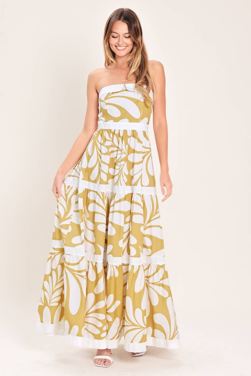 A printed woven maxi dress featuring strapless neckline, tier skirt and back zipper closure