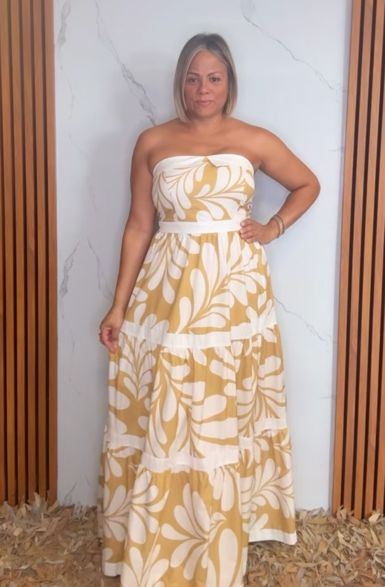 A printed woven maxi dress featuring strapless neckline, tier skirt and back zipper closure