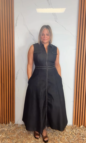 A solid woven midi dress featuring collar, sleeveless, front zipper closure, stud embellishments, side pockets and circle skirt