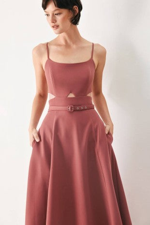 A solid woven midi dress featuring cam top, cut out at waistline, self belt, circle skirt and back zipper closure