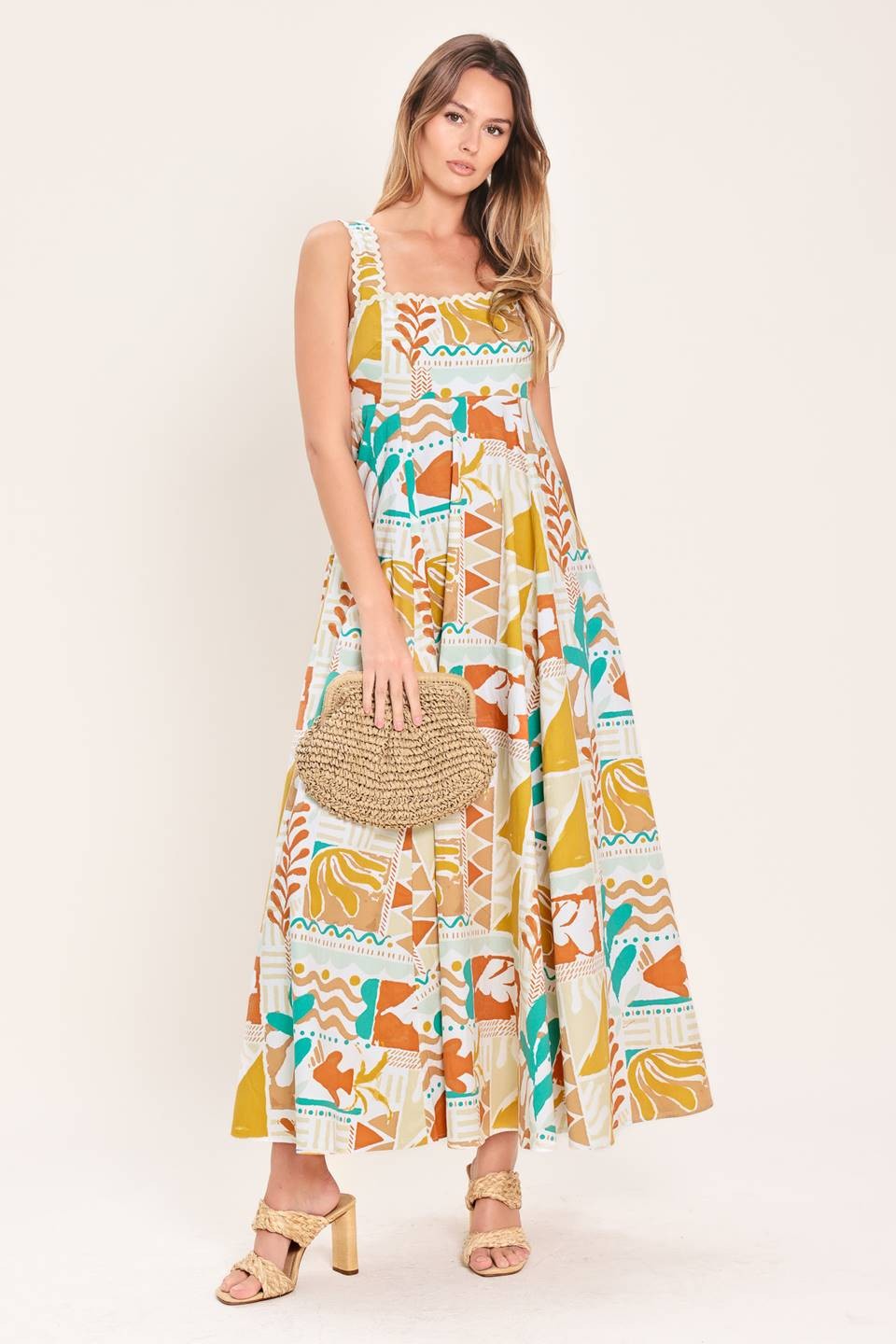 A printed woven midi dress featuring straight neckline with ric-rac ribbon trim, circle skirt and smocked back bodice