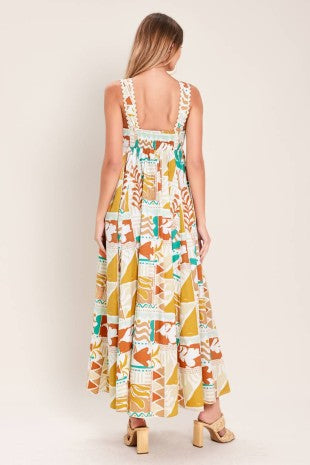 A printed woven midi dress featuring straight neckline with ric-rac ribbon trim, circle skirt and smocked back bodice