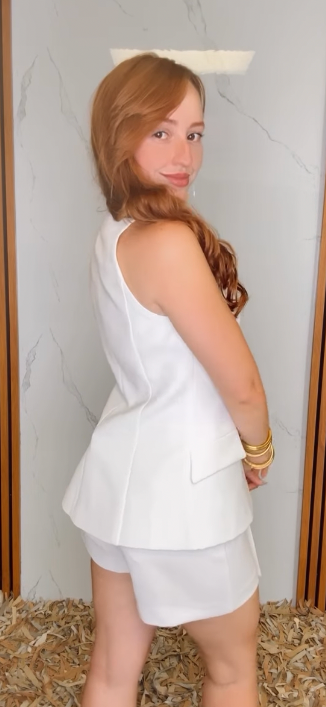 A solid woven vest featuring sweetheart neckline, button down and peplum.