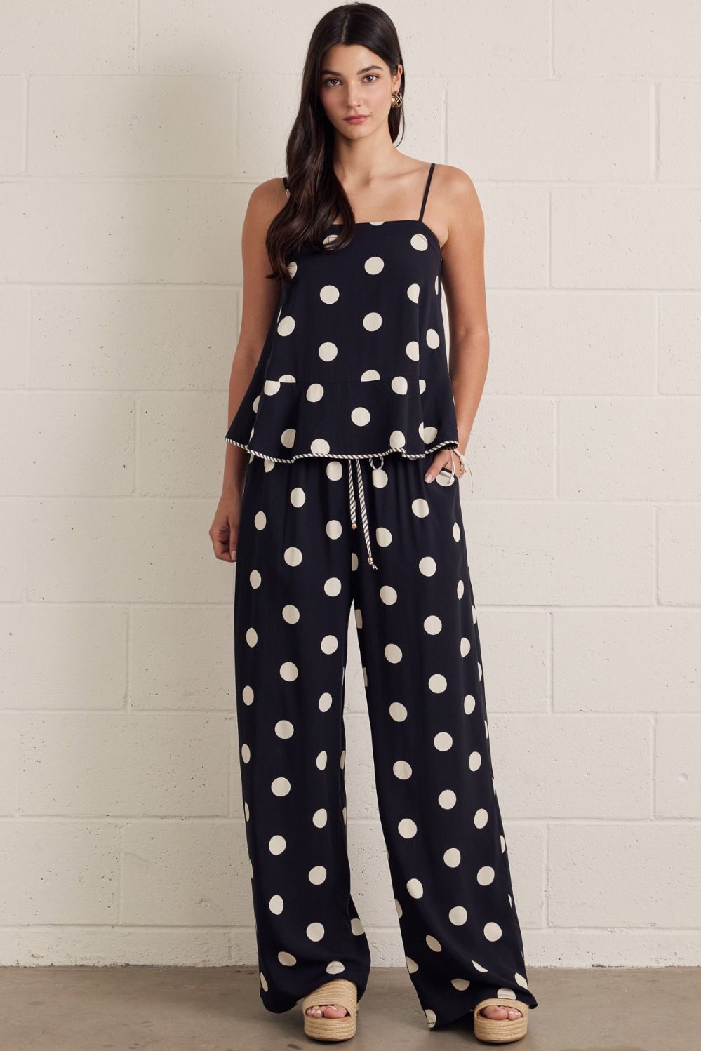 Polka dot sleeveless peplum top featuring square neckline