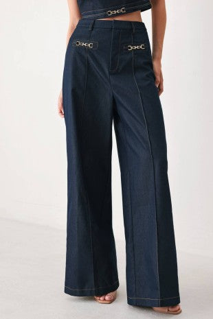 A solid woven wide leg pant with front closure and hardware detail