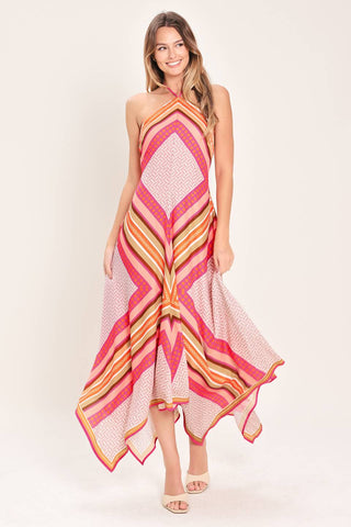 A printed woven midi dress featuring halter neckline with tie, hanky hem and back zipper closure