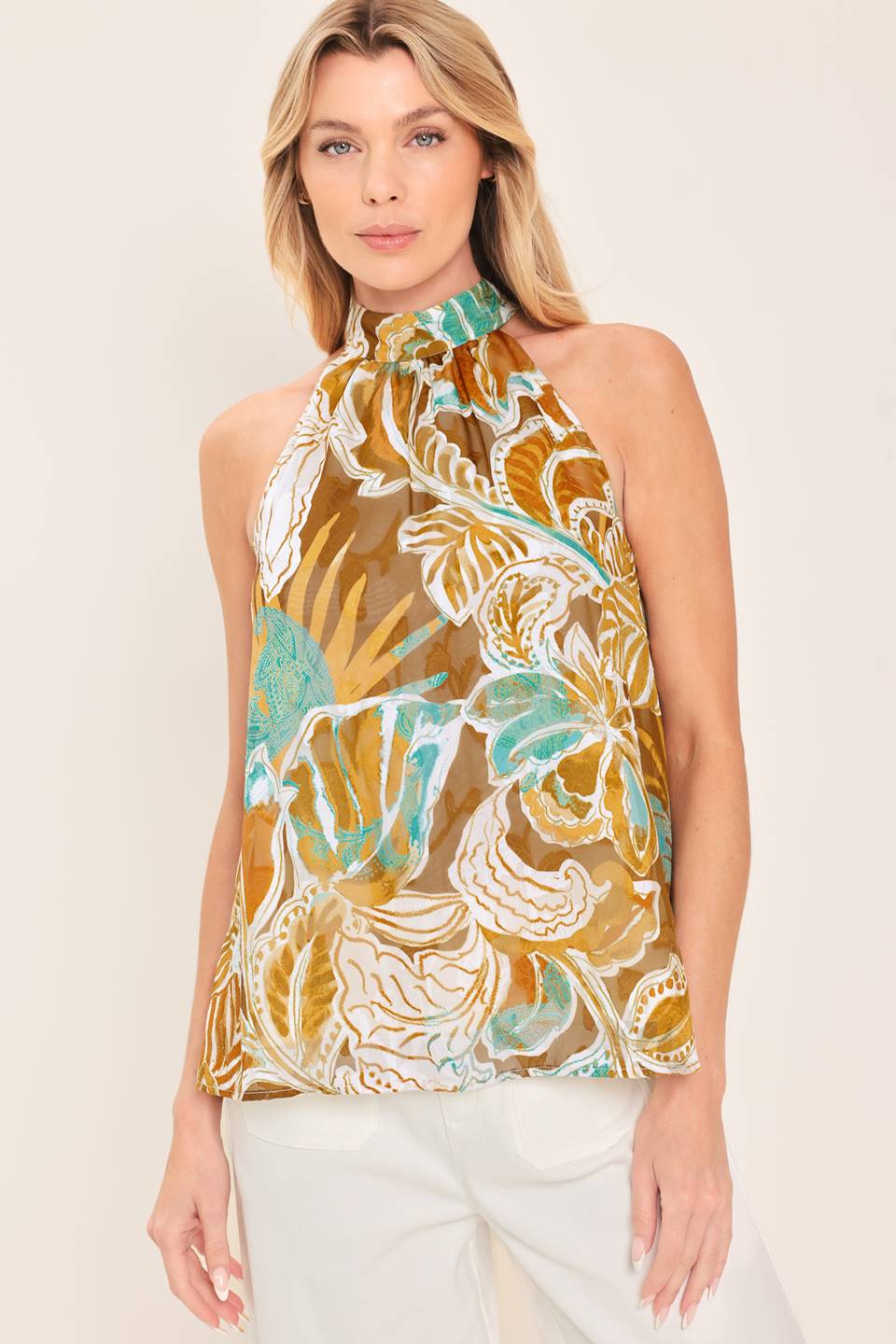A woven jacquard printed top with halter neckline with back neck tie.
