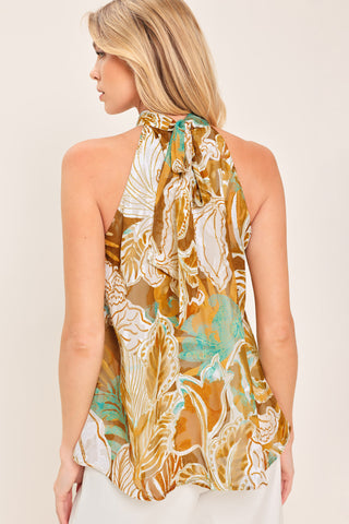 A woven jacquard printed top with halter neckline with back neck tie.