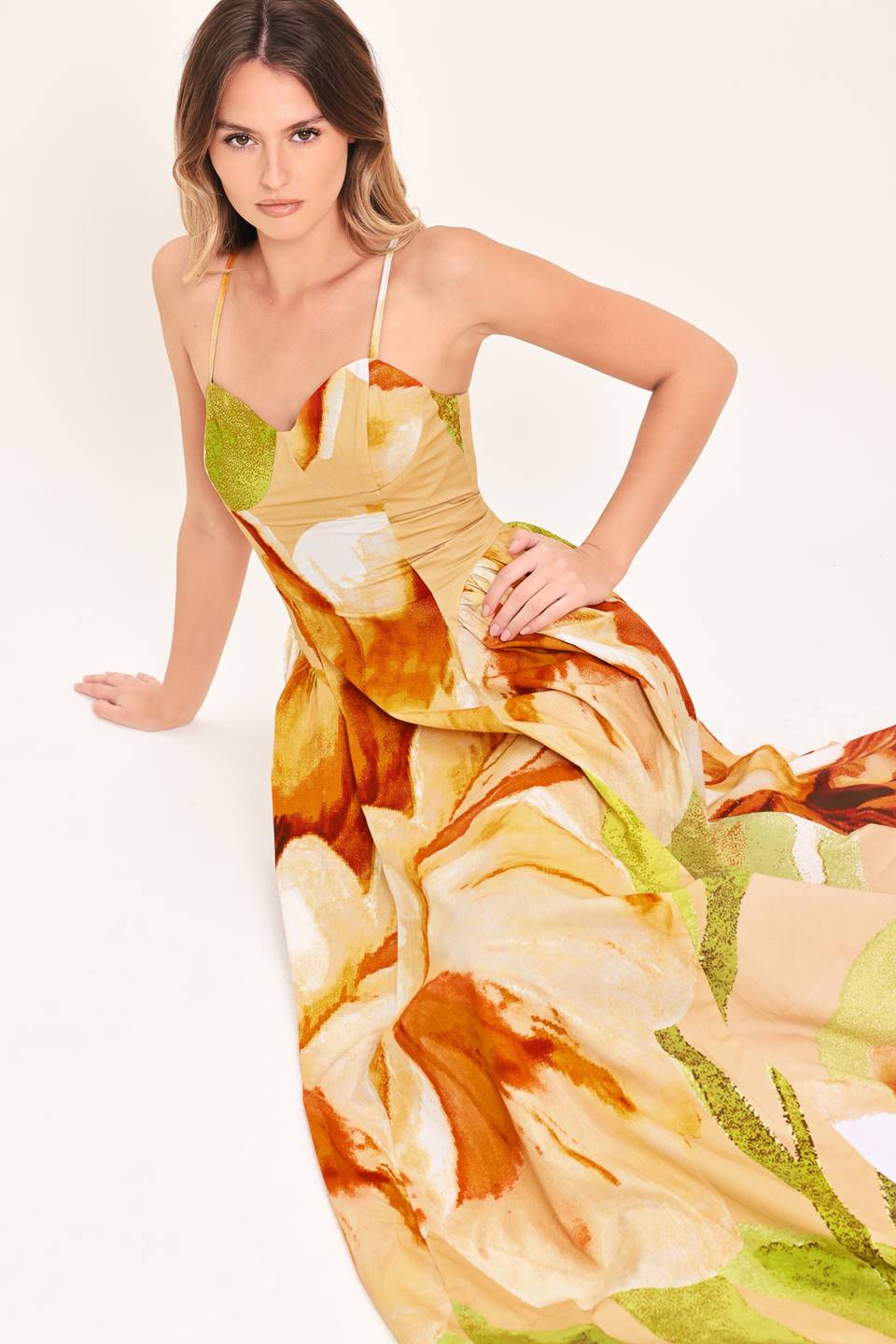 A printed woven maxi dress featuring bustier top, straps, side shirring detail and back zipper closure