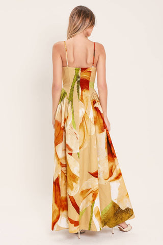 A printed woven maxi dress featuring bustier top, straps, side shirring detail and back zipper closure