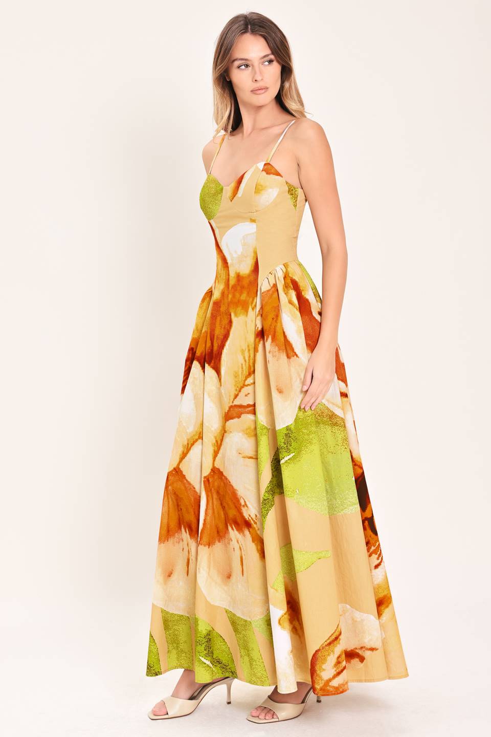 A printed woven maxi dress featuring bustier top, straps, side shirring detail and back zipper closure