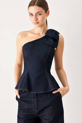 A denim top featuring one shoulder neckline with bow, peplum and back zipper