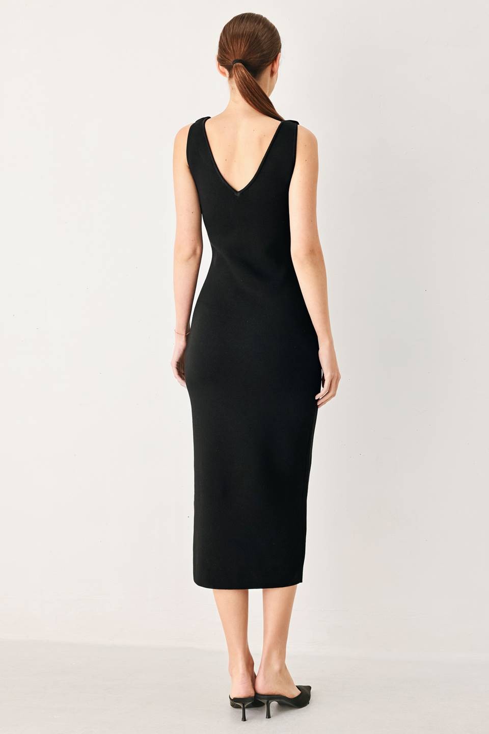 A sweater knit midi dress featuring V neckline and side cut out