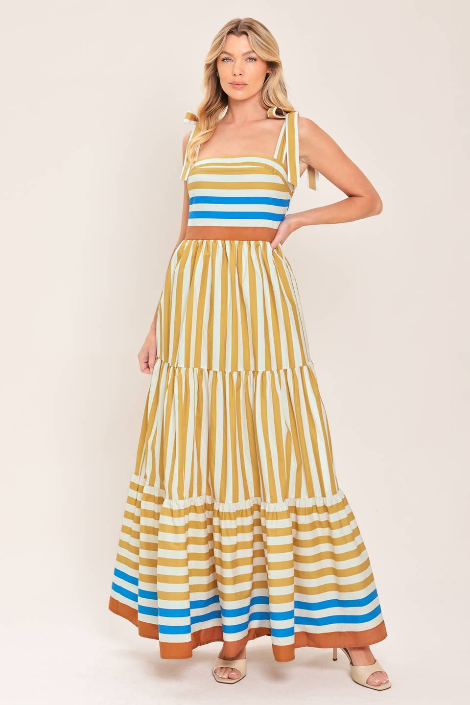 A printed woven maxi dress featuring shoulder ties, tier skirt and smocked back