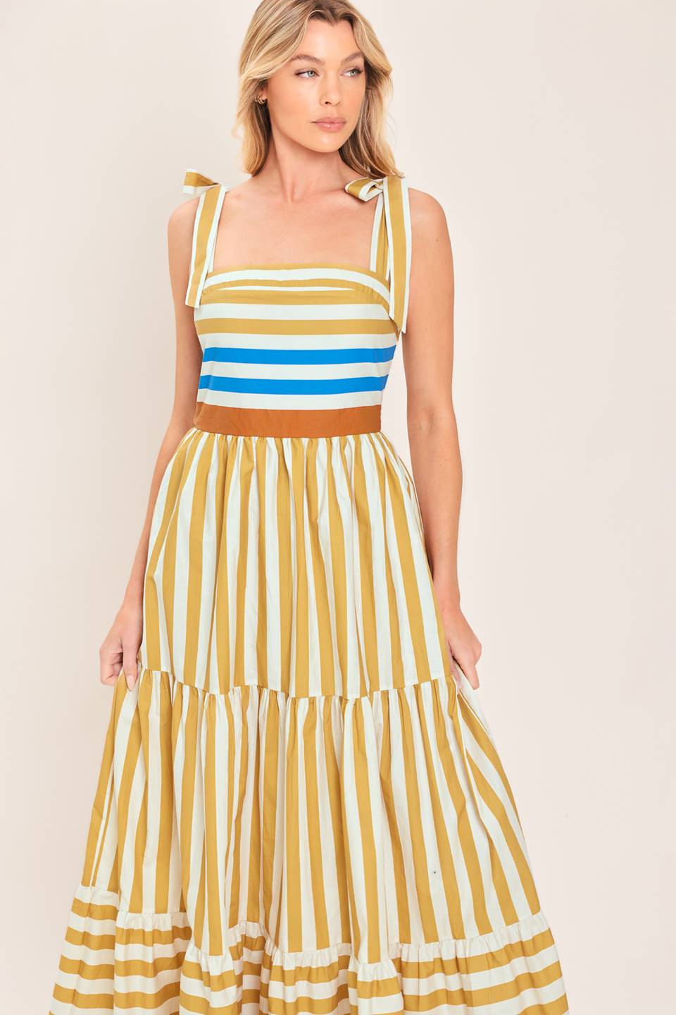 A printed woven maxi dress featuring shoulder ties, tier skirt and smocked back
