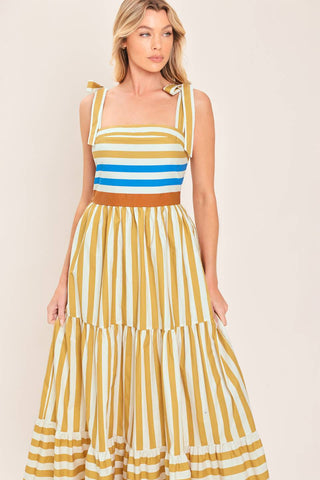 A printed woven maxi dress featuring shoulder ties, tier skirt and smocked back