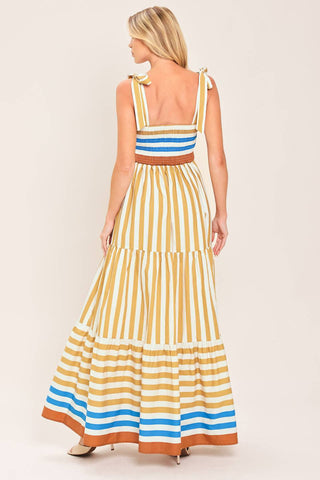A printed woven maxi dress featuring shoulder ties, tier skirt and smocked back