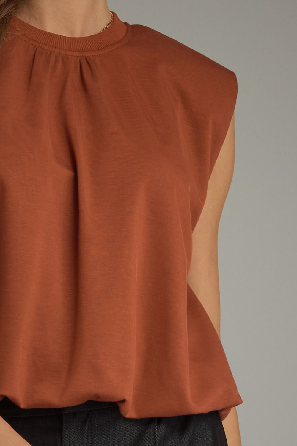 Solid cap sleeve top featuring gathered round neckline