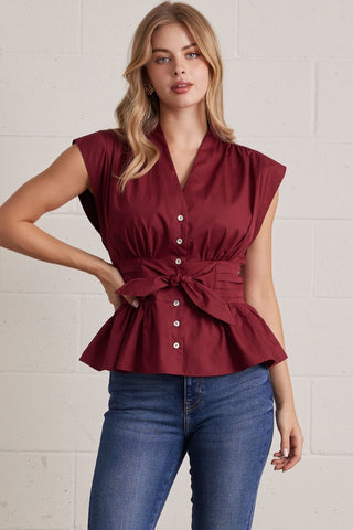 Solid V-neck sleeveless blouse featuring self-tie waist detail