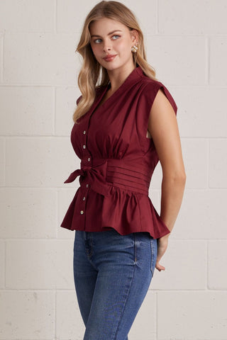 Solid V-neck sleeveless blouse featuring self-tie waist detail