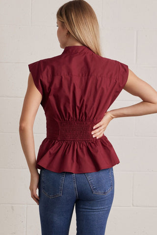 Solid V-neck sleeveless blouse featuring self-tie waist detail