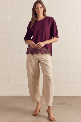Solid short sleeve knit top featuring scallop lace hem detail