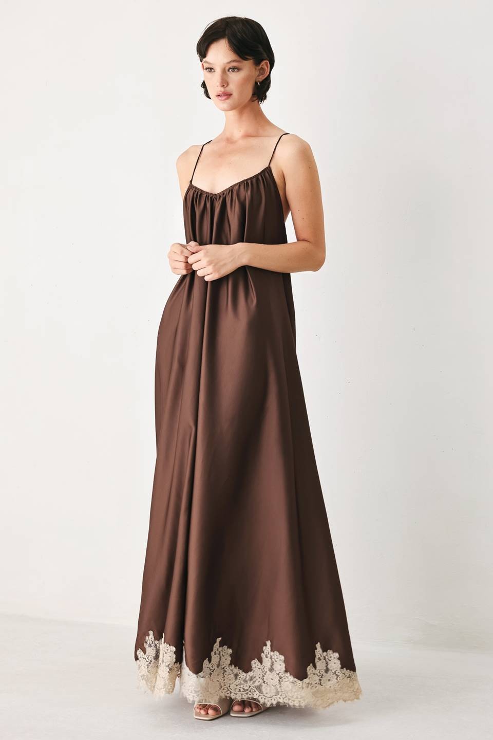 A solid woven midi slip dress with lace hem