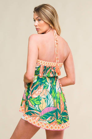 A printed woven top featuring halter tie, O ring at the center