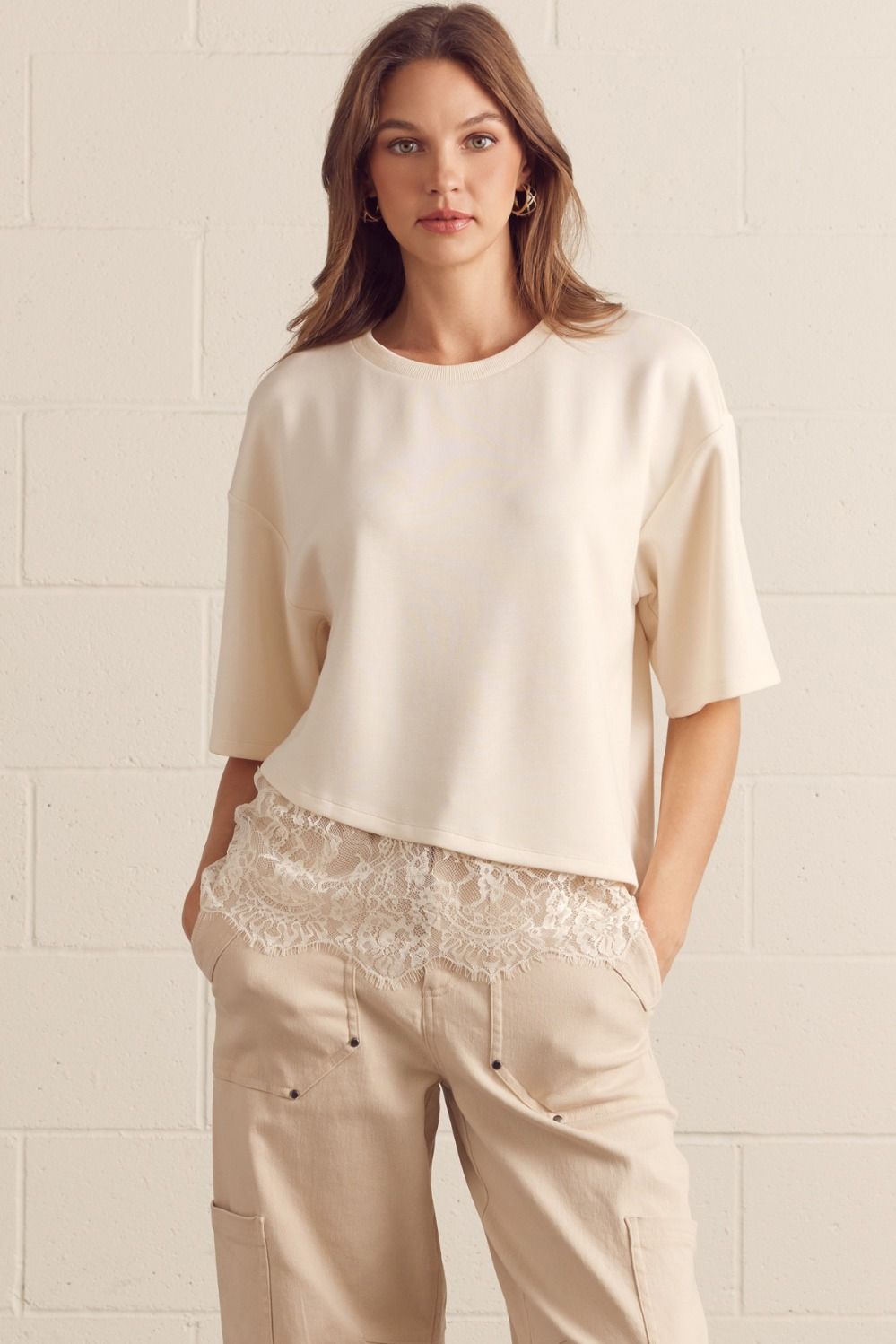 Solid short sleeve knit top featuring scallop lace hem detail