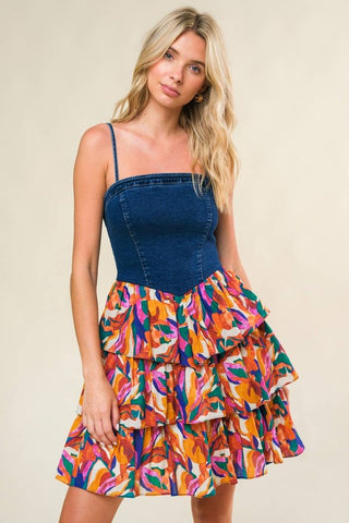 A denim/printed woven midi dress featuring straight neckline, straps, layered skirt and back zipper closure