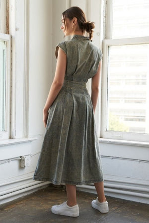 An overdyed denim midi dress featuring shirt collar, sleeveless, button down, self sash belt and full skirt