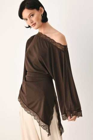 A solid knit top with boat neckline, bell sleeve, asymmetrical hem and lace edge