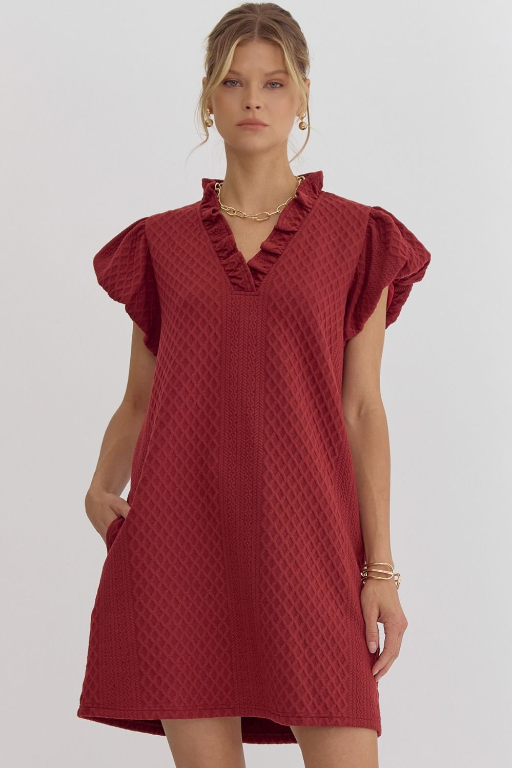 Textured short-sleeve v-neck mini dress featuring bubble sleeves.